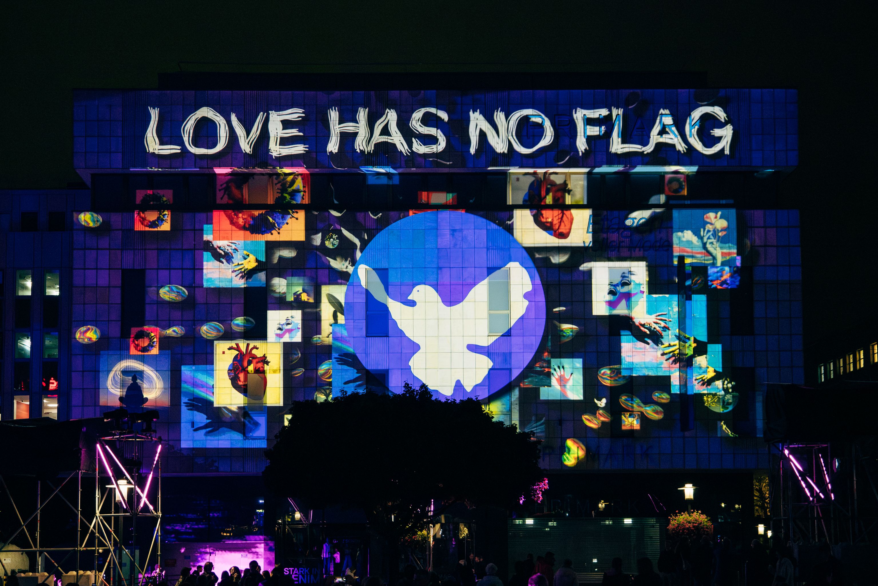 Love has no flag and a dove projected onto the Primark facade